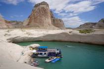 A houseboat rests in a cove at Lake Powell near Page, Ariz., in July 2021. (AP Photo/Rick Bowmer)