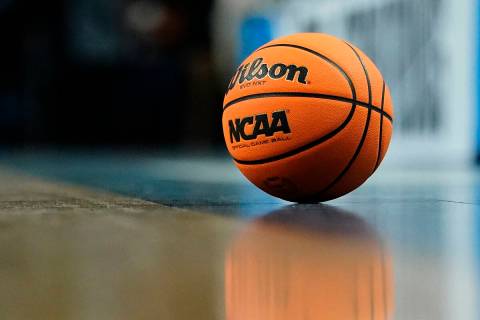 A game ball sits on the floor during a break in play of a college basketball game between Arkan ...