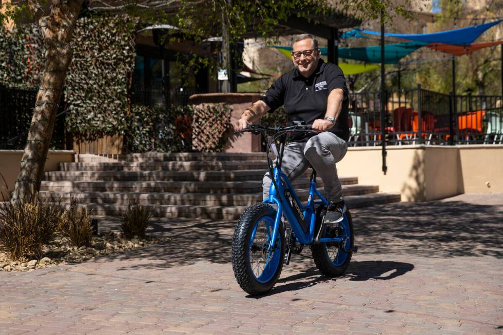 Jordan Clark, owner of Pedego Lake Las Vegas, rides a outside of his Henderson shop, Wednesday, ...