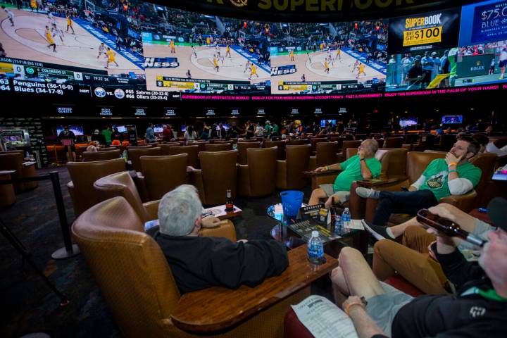 Fans look to the big screens as March Madness begins in the Superbook at Westgate on Thursday, ...