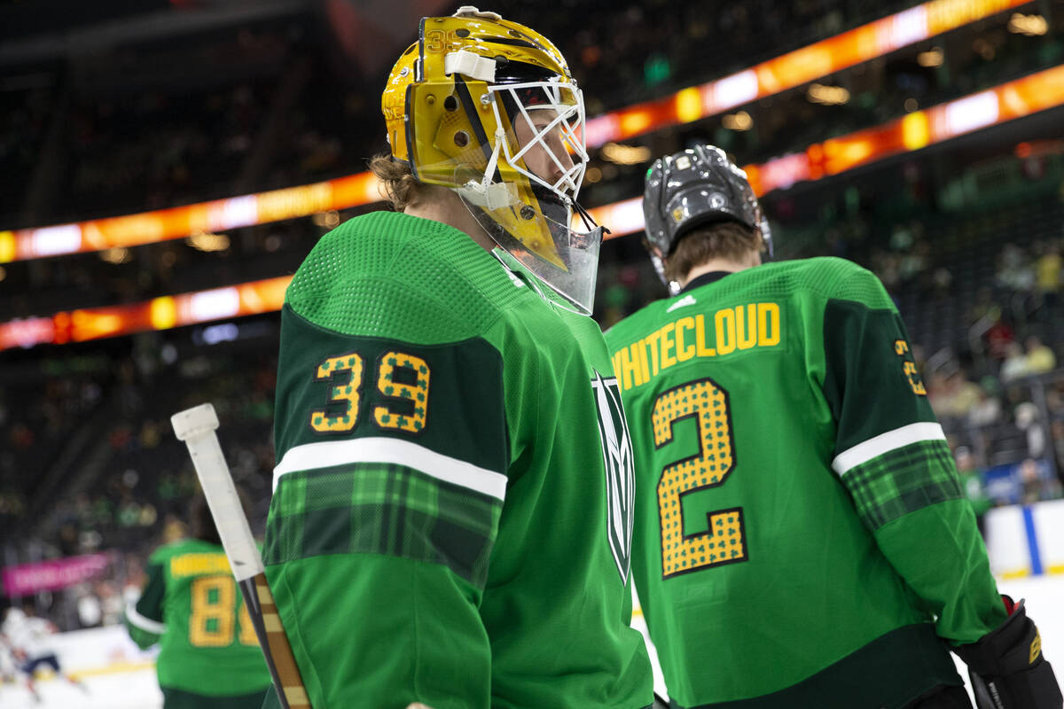 Golden Knights goaltender Laurent Brossoit (39) and defenseman Zach Whitecloud (2) wear St. Pat ...