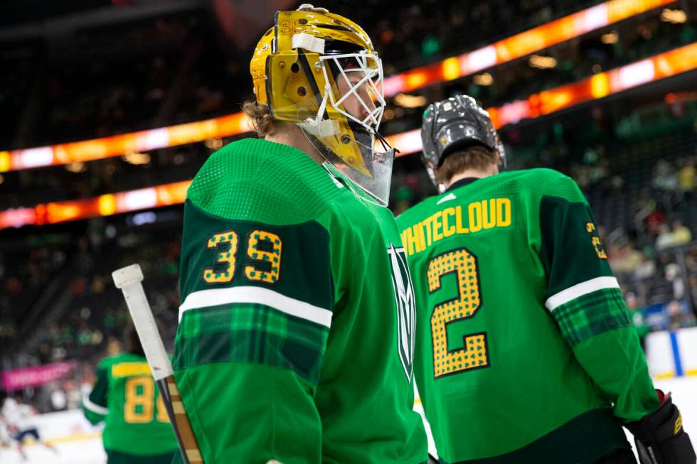 Golden Knights goaltender Laurent Brossoit (39) and defenseman Zach Whitecloud (2) wear St. Pat ...