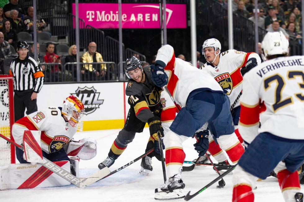 Golden Knights center Nicolas Roy (10) reaches for the puck against Panthers goaltender Spencer ...