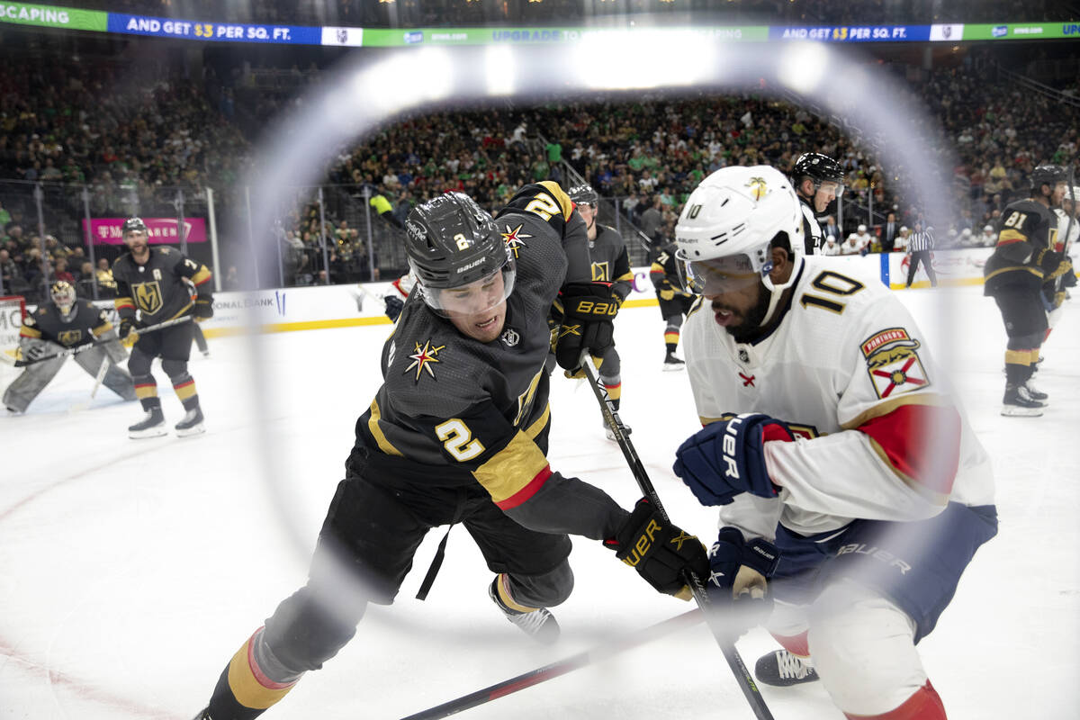 Golden Knights defenseman Zach Whitecloud (2) and Panthers left wing Anthony Duclair (10) skate ...