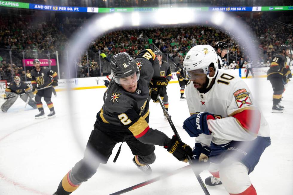 Golden Knights defenseman Zach Whitecloud (2) and Panthers left wing Anthony Duclair (10) skate ...