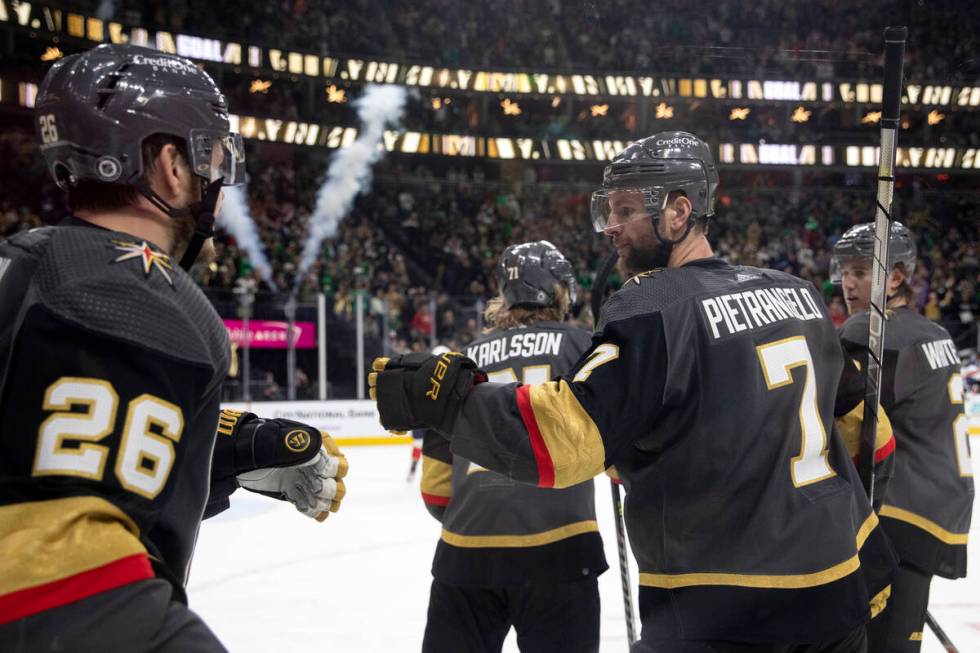 Golden Knights center Mattias Janmark (26) and defenseman Alex Pietrangelo (7) celebrate after ...