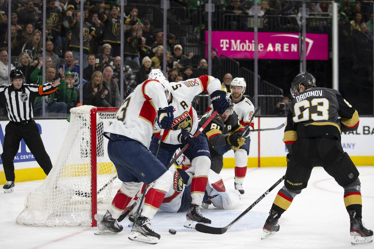 Panthers center Carter Verhaeghe (23) and defenseman Aaron Ekblad (5) keep a puck shot by Golde ...