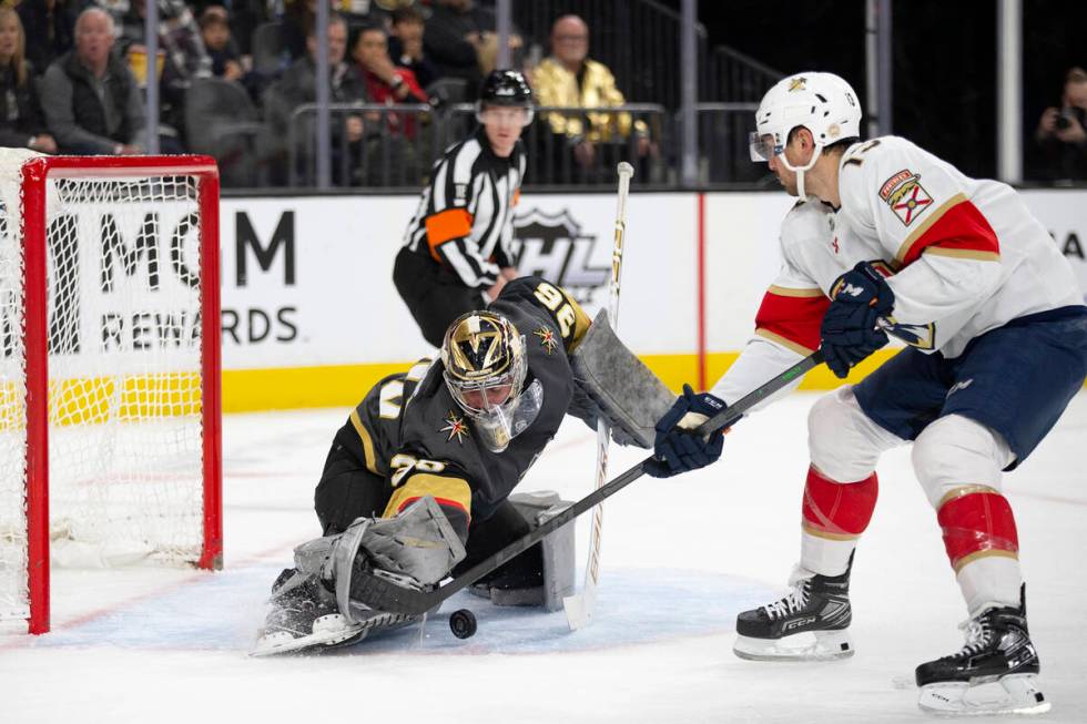 Golden Knights goaltender Logan Thompson (36) saves a shot by Panthers center Sam Reinhart (13) ...