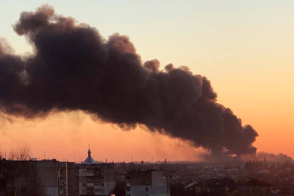A cloud of smoke raises after an explosion in Lviv, western Ukraine, Friday, March 18, 2022. Th ...