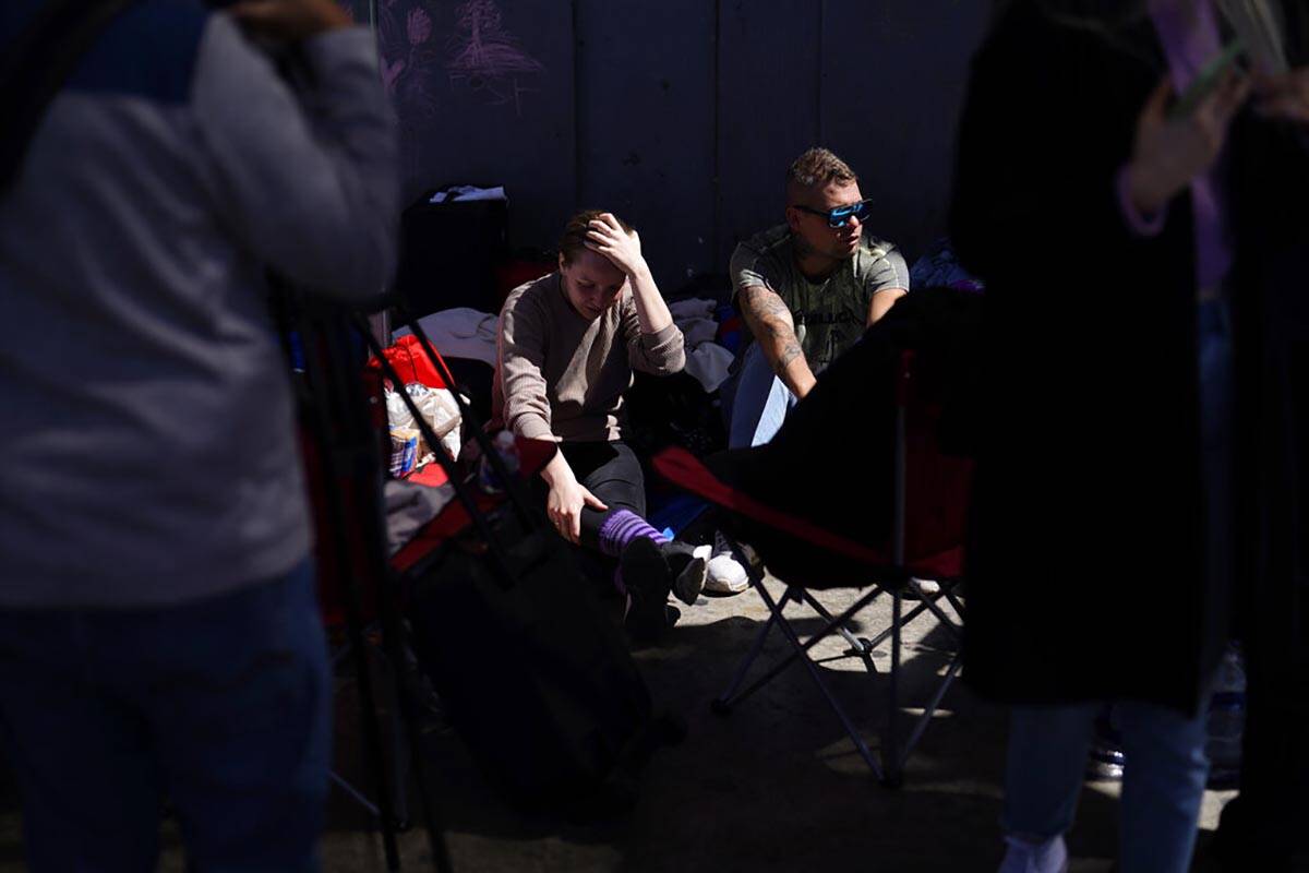 A couple from Russia seeking asylum wait near the San Ysidro Port of Entry into the United Stat ...