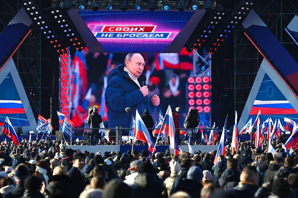 Russian President Vladimir Putin seen on the big screen as he delivers his speech at the concer ...