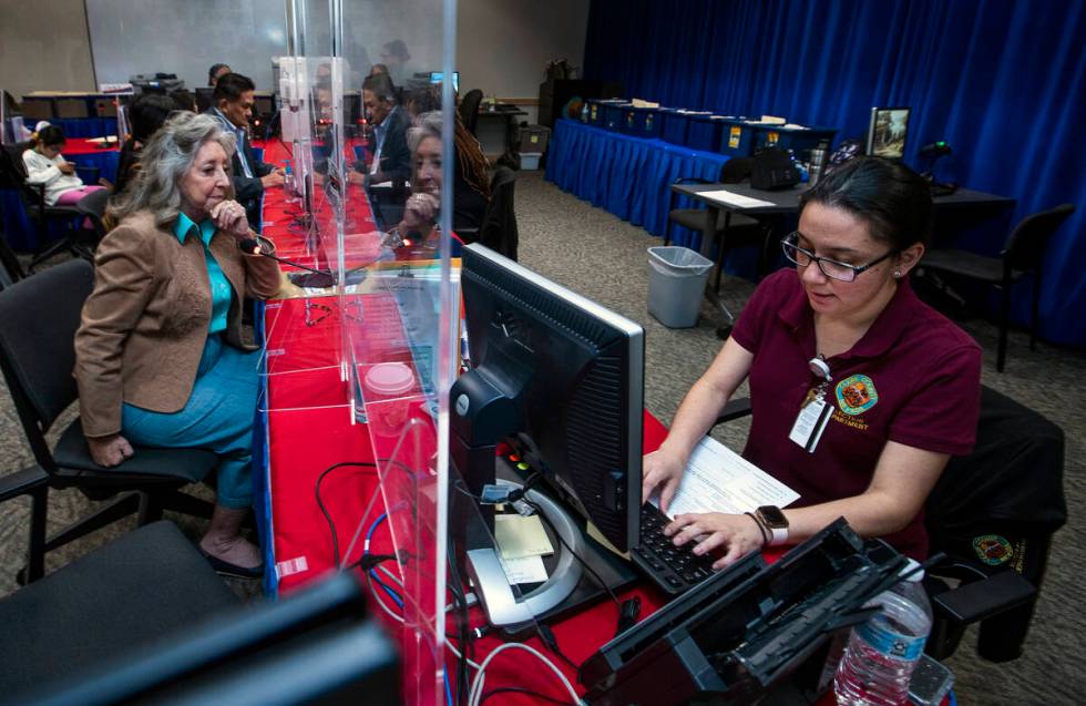 Rep. Dina Titus, D-Nev., left, looks to Election Operations Specialist Lupita Ramirez as she fi ...