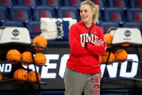 UNLV coach Lindy La Rocque smiles while watching the team shoot layups during practice for the ...