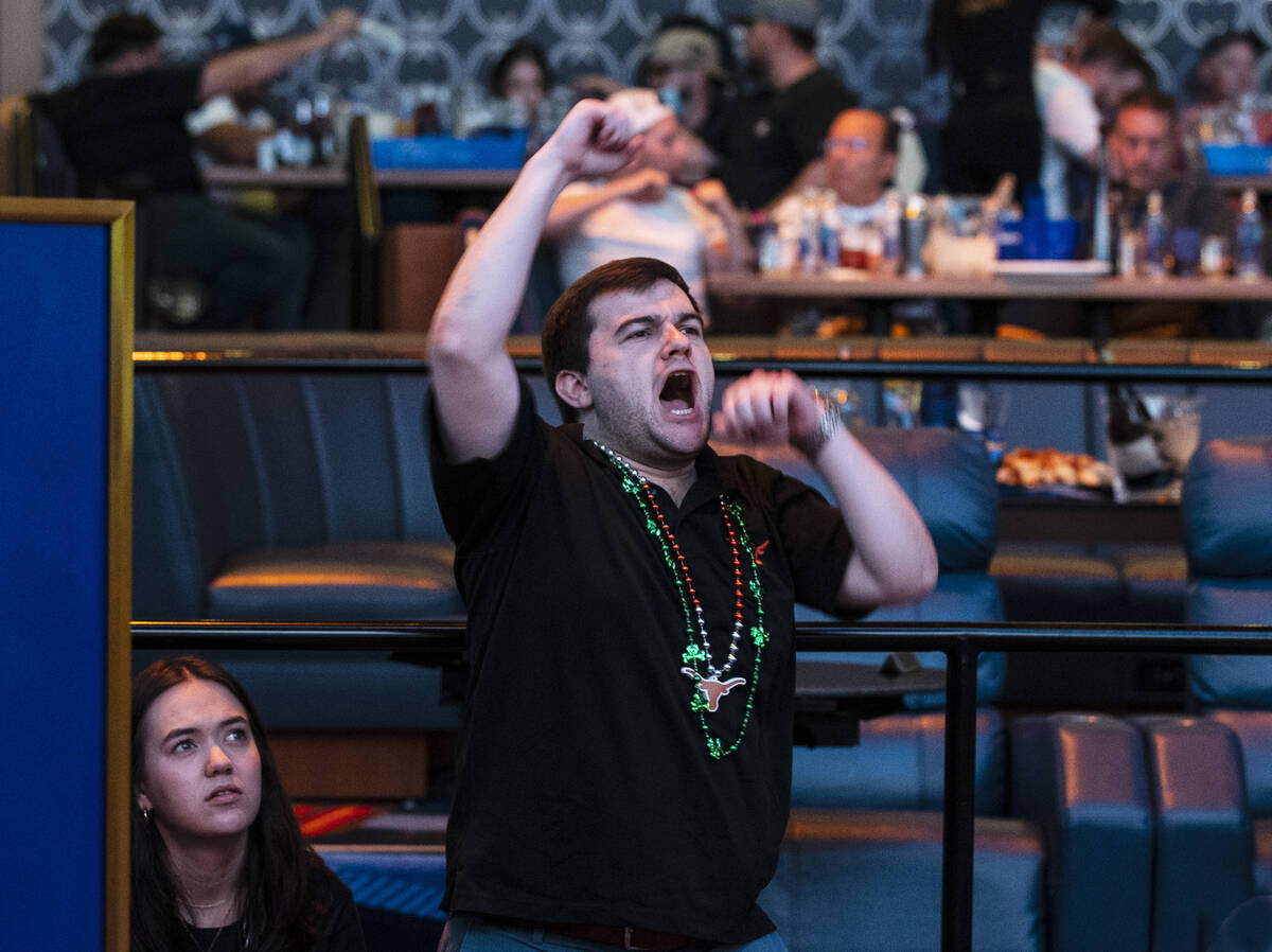 Justin Hollenberg of Texas reacts to a basketball game being played on the second day of March ...