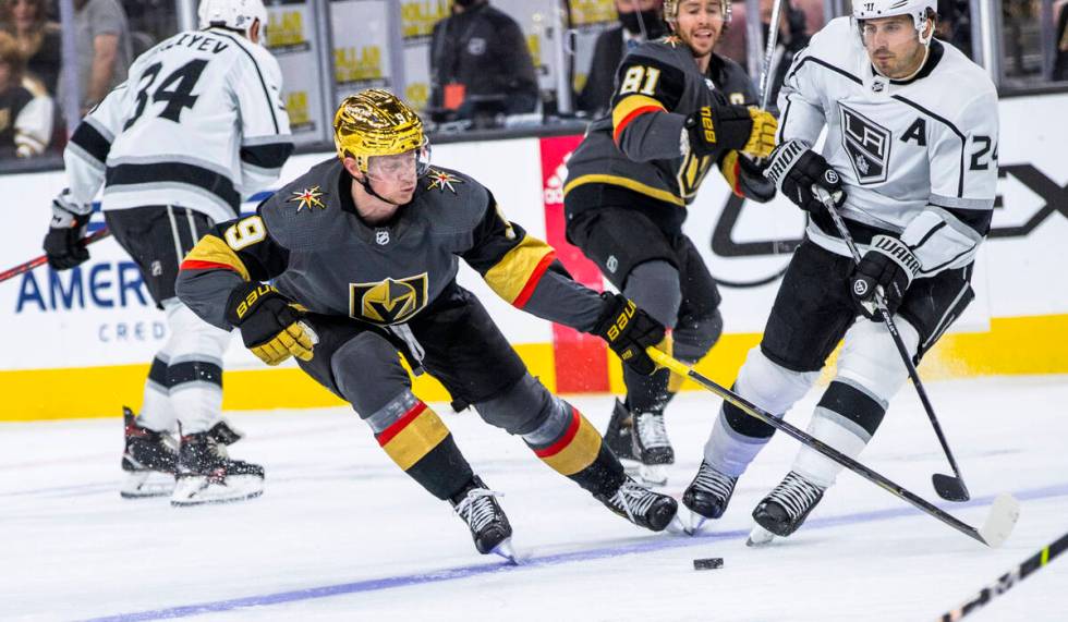 Golden Knights center Jack Eichel (9) looks to control the puck with Los Angeles Kings center P ...