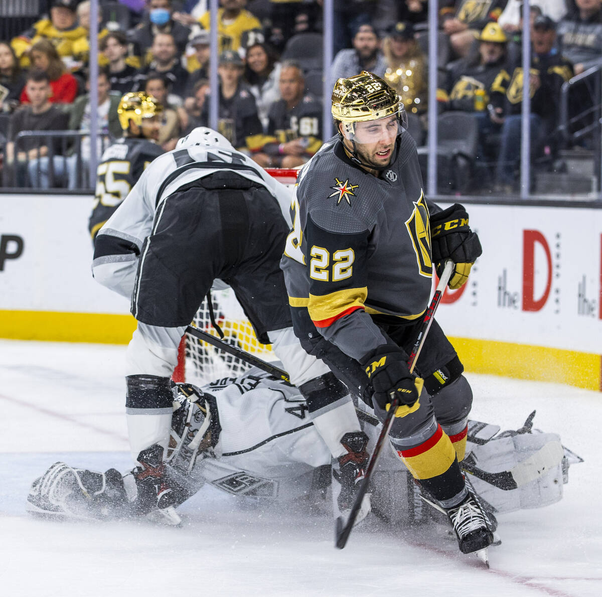 Golden Knights center Michael Amadio (22) slides the puck beneath Los Angeles Kings goaltender ...