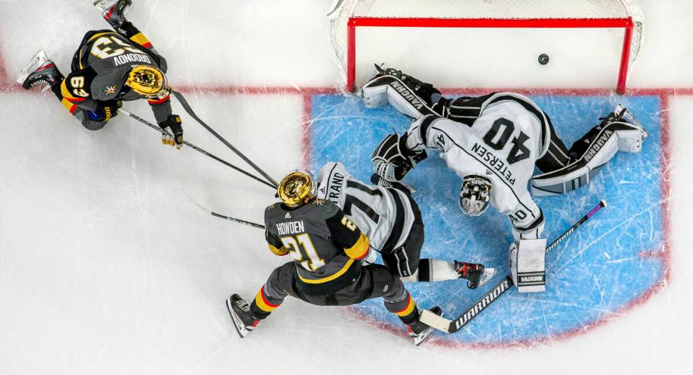 Golden Knights right wing Evgenii Dadonov (63) scores on Los Angeles Kings goaltender Cal Peter ...