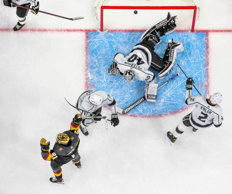 Golden Knights center Brett Howden (21) celebrates a goal by by teammate right wing Evgenii Dad ...