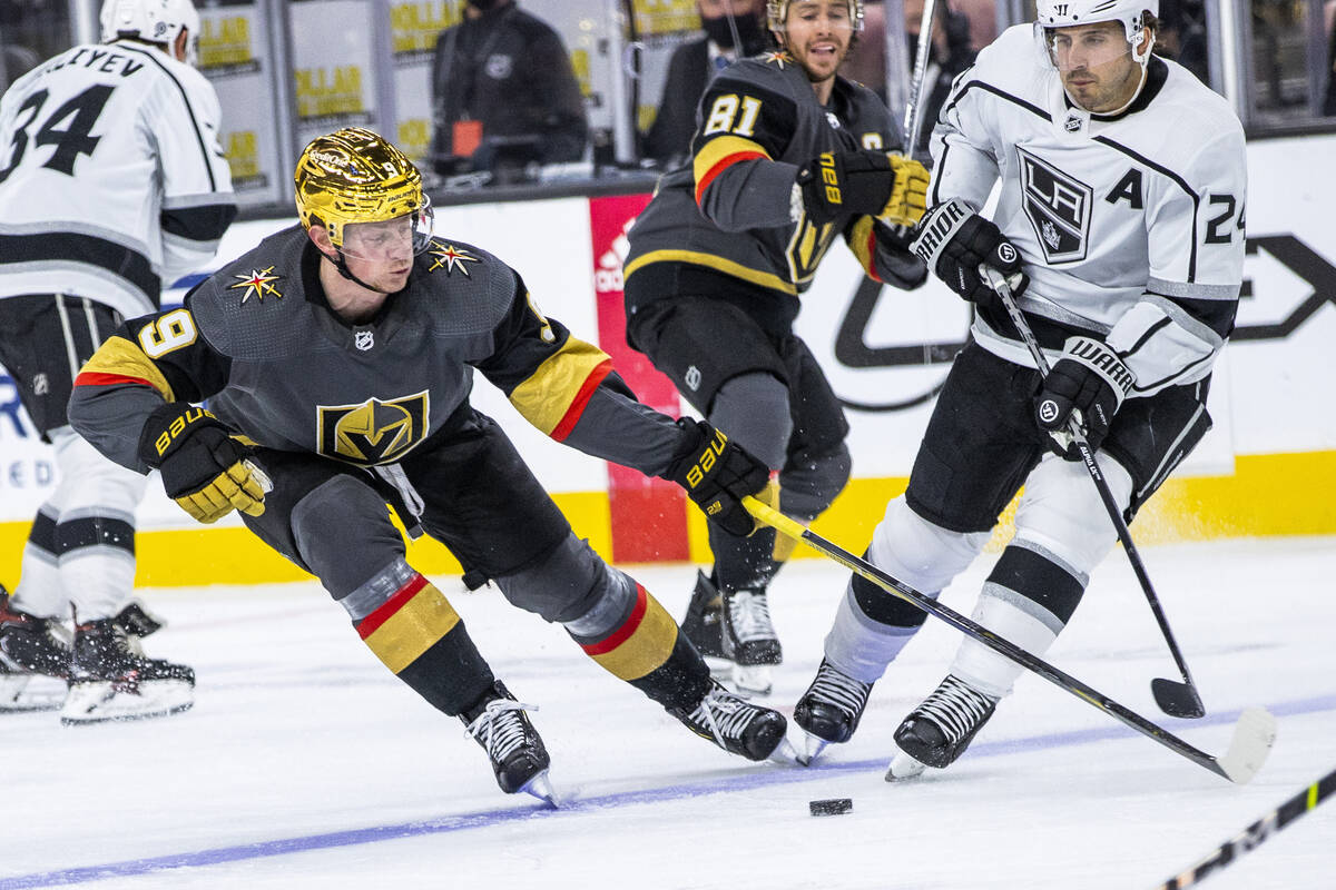 Golden Knights center Jack Eichel (9) looks to control the puck with Los Angeles Kings center P ...