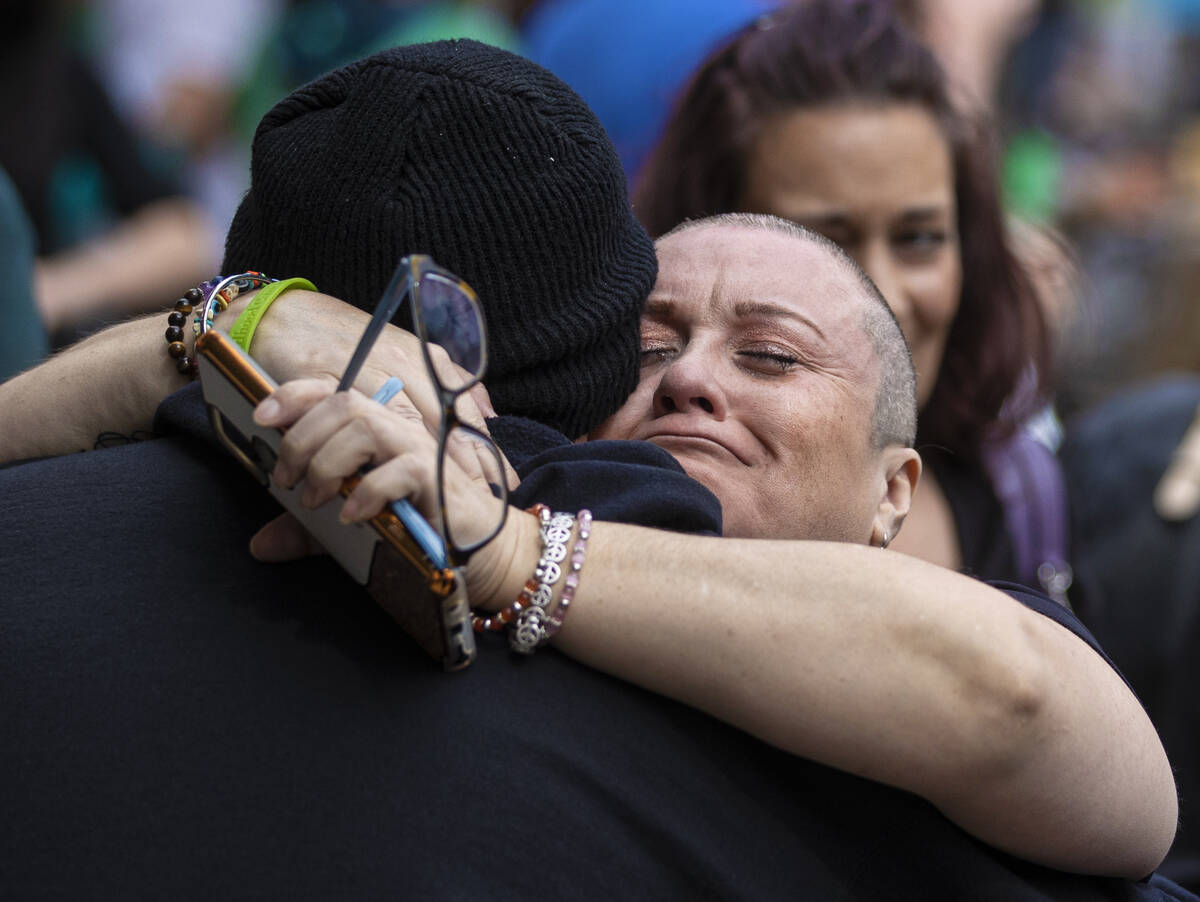 Kris Jordan hugs friends and family after having her head shaved in honor of her nephew Gunner ...