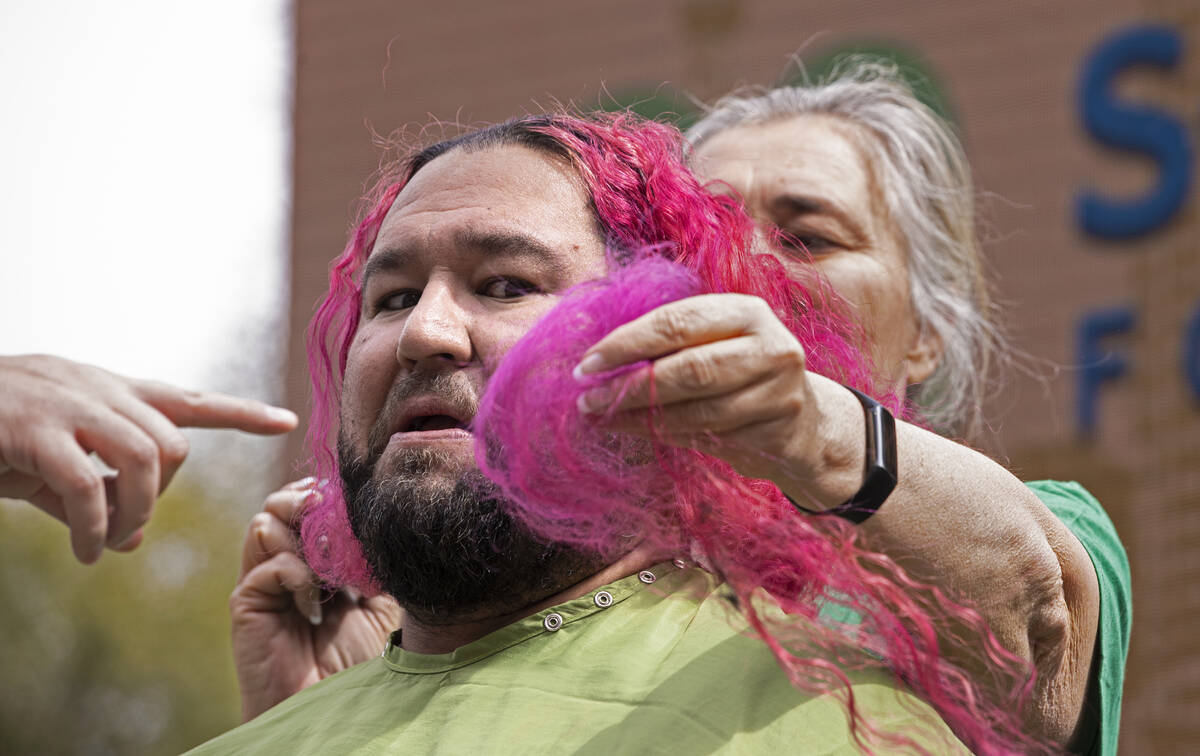 Gabriel Cadena gets a first look at a lock of his shaved hair during the annual St. Baldrick's ...