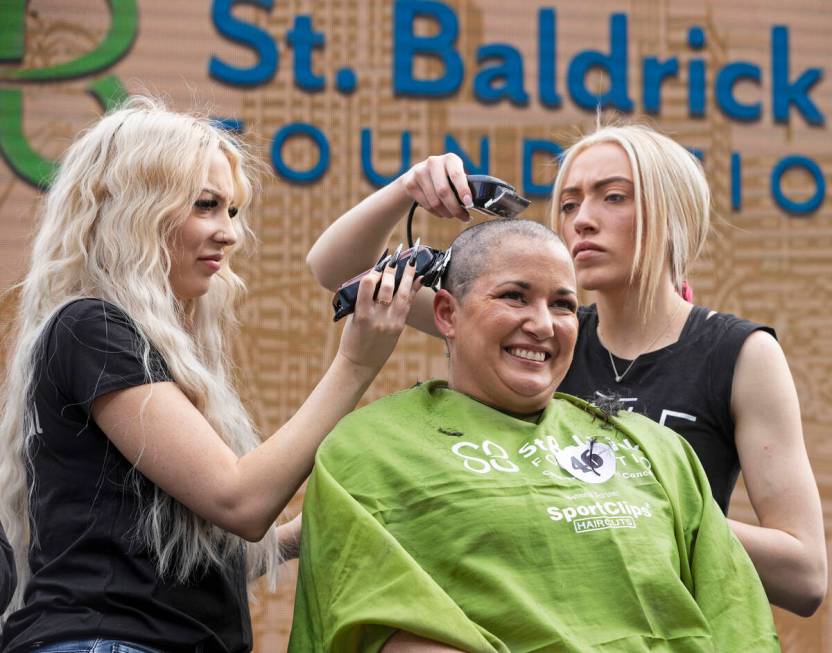 Gabrielle Scanlon, middle, has her head shaved during the annual St. Baldrick's fundraising eve ...