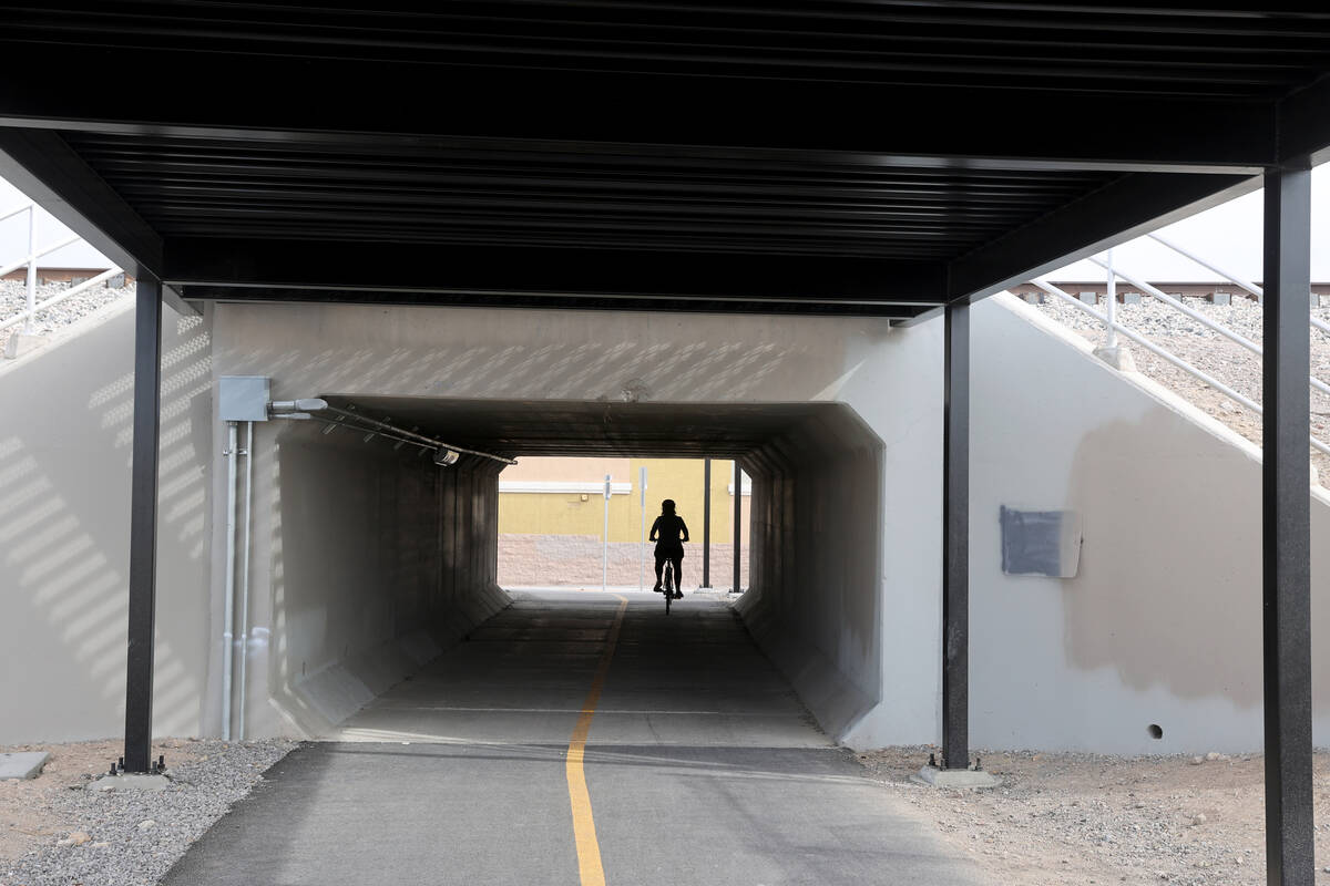A cyclist rides their bike during the opening of The Harry Reid Union Pacific Railroad Trail ex ...