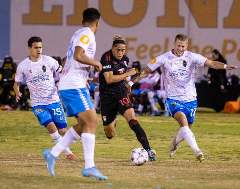 Phoenix Rising’s forward Arturo Rodriguez (10) dribbles between Las Vegas Lights’ ...