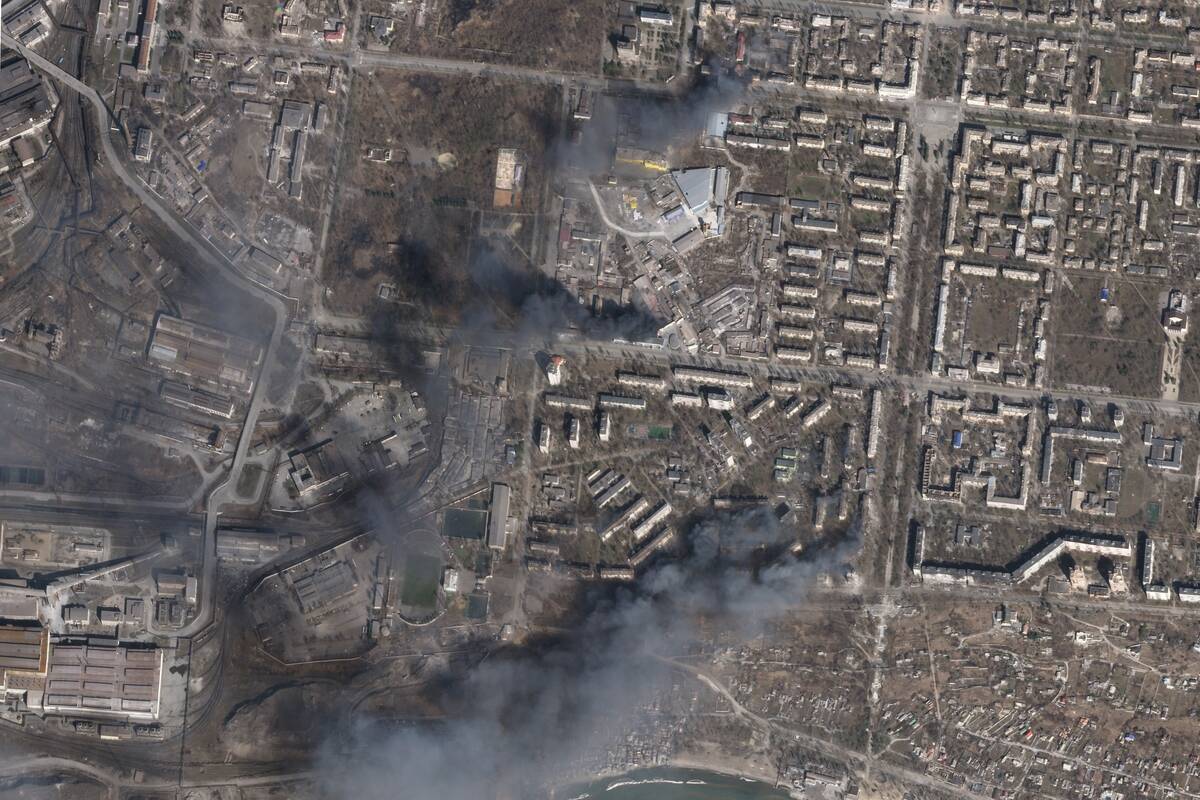 In this satellite photo from Planet Labs PBC, multiple civilian buildings burn amid Russian str ...