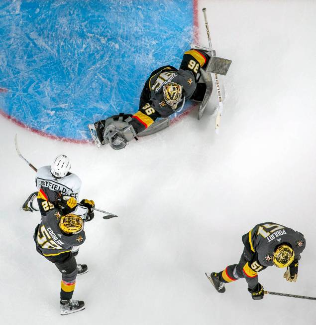 Golden Knights goaltender Logan Thompson (36) extends for a save over Los Angeles Kings center ...