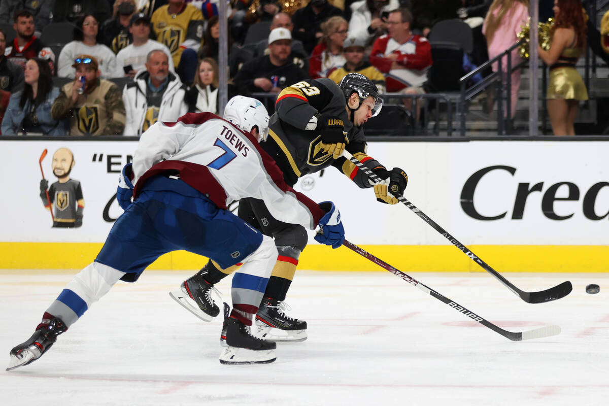 Vegas Golden Knights right wing Evgenii Dadonov (63) shoots the puck under pressure from Colora ...
