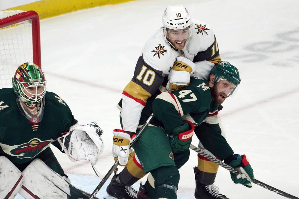 Minnesota Wild's Alex Goligoski (47) keeps Vegas Golden Knights' Nicolas Roy (10) at bay as he ...