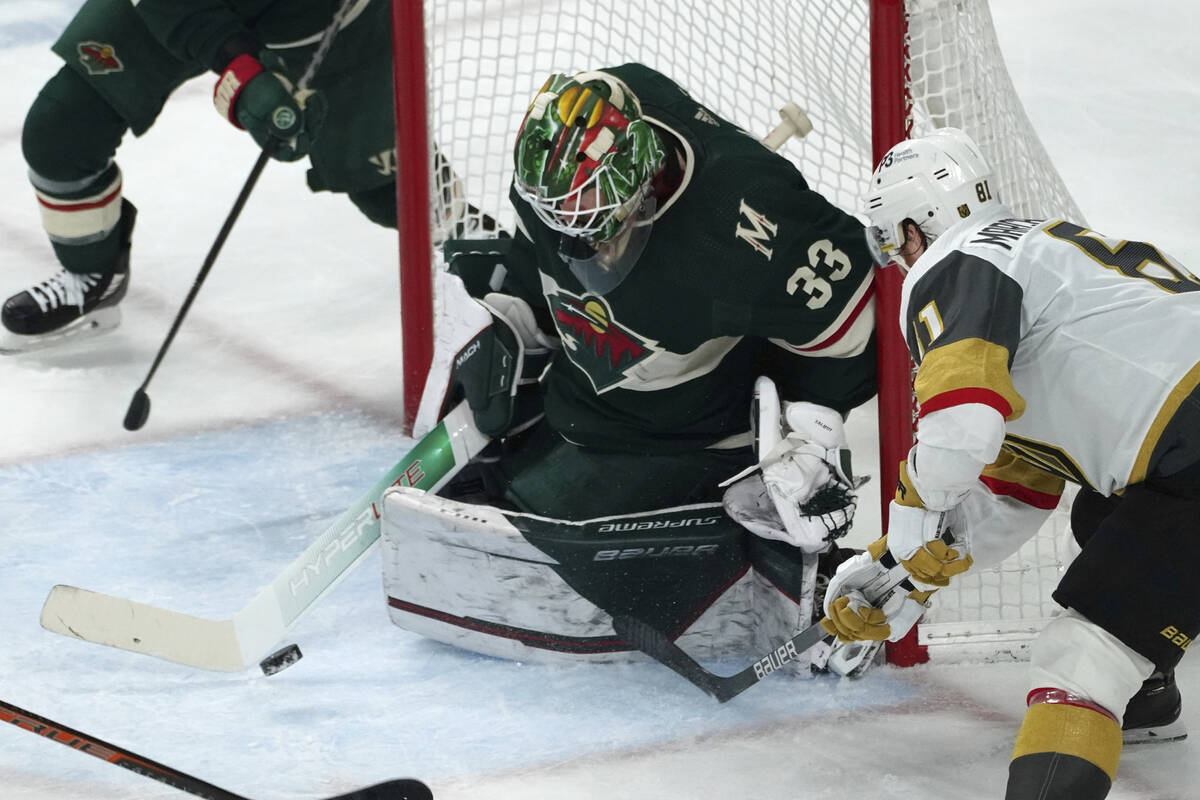 Minnesota Wild goalie Cam Talbot (33) stops a shot as Vegas Golden Knights' Jonathan Marchessau ...