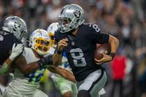 Raiders quarterback Marcus Mariota (8) carries the football against the Los Angeles Chargers du ...