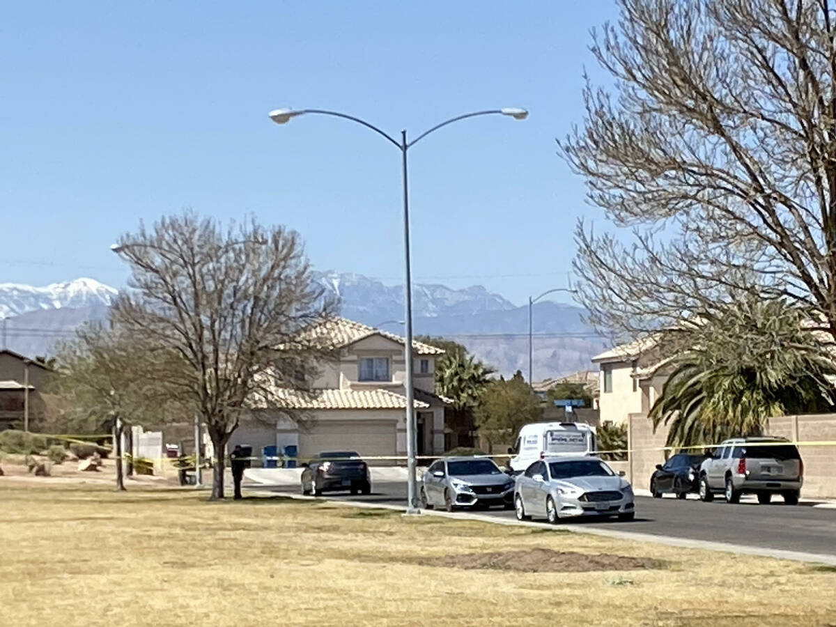 Homicide investigators in North Las Vegas block off a large swathe of an upscale neighborhood, ...