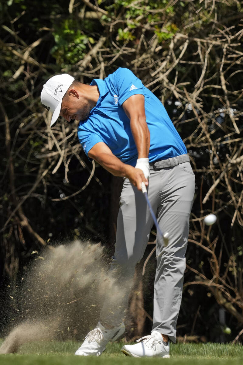 Xander Schauffele takes a divot as he tees off on the third hole during the final round of the ...