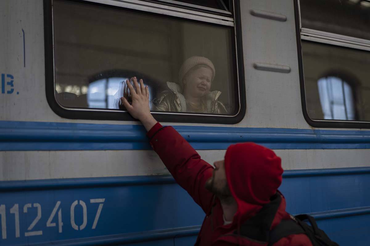 Displaced Ukrainians on a Poland-bound train bid farewell in Lviv, western Ukraine, Tuesday, Ma ...
