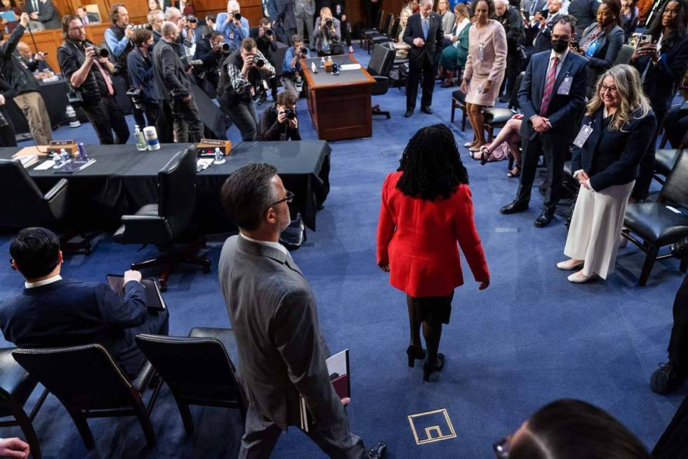 Supreme Court nominee Ketanji Brown Jackson, in red, followed by her husband Dr. Patrick Jackso ...