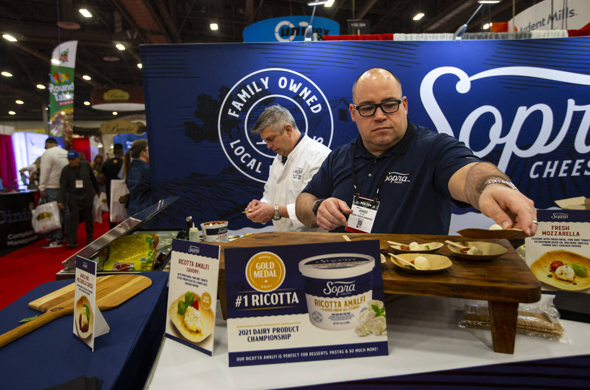 James Russo, chief administrative officer of Sopra Cheese, plates samples during the Internatio ...