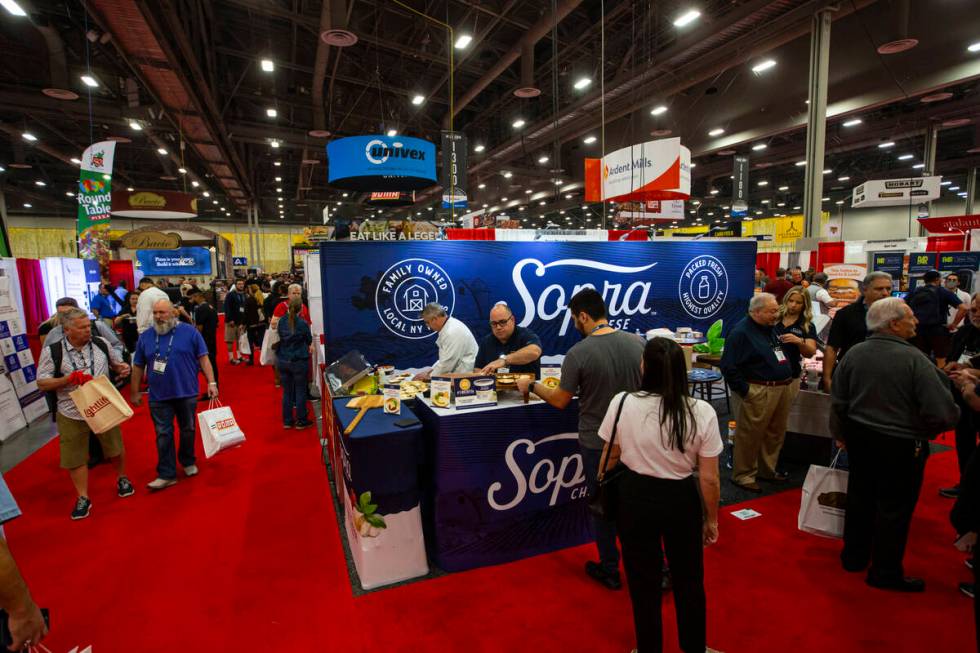 Attendees walk the show floor and try samples during the International Pizza Expo at the Las Ve ...