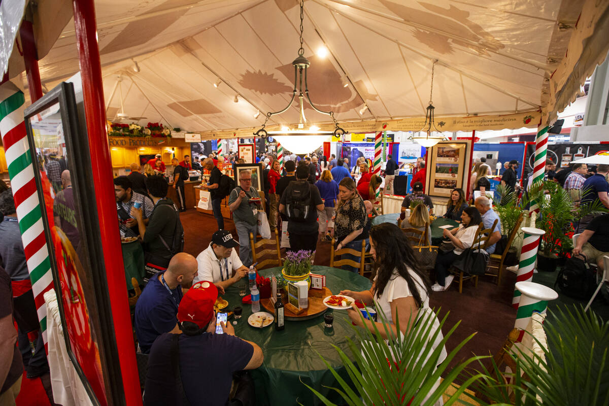 Attendees enjoy bites to eat at the Stanislaus Food Products and Corto Olive Co. booth during t ...
