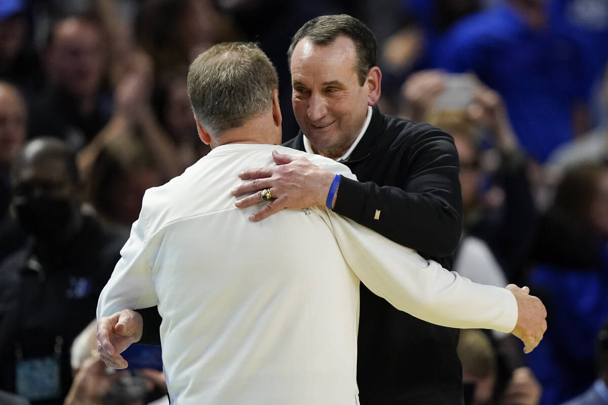 Duke head coach Mike Krzyzewski hugs Michigan State head coach Tom Izzo after Duke's win in a c ...
