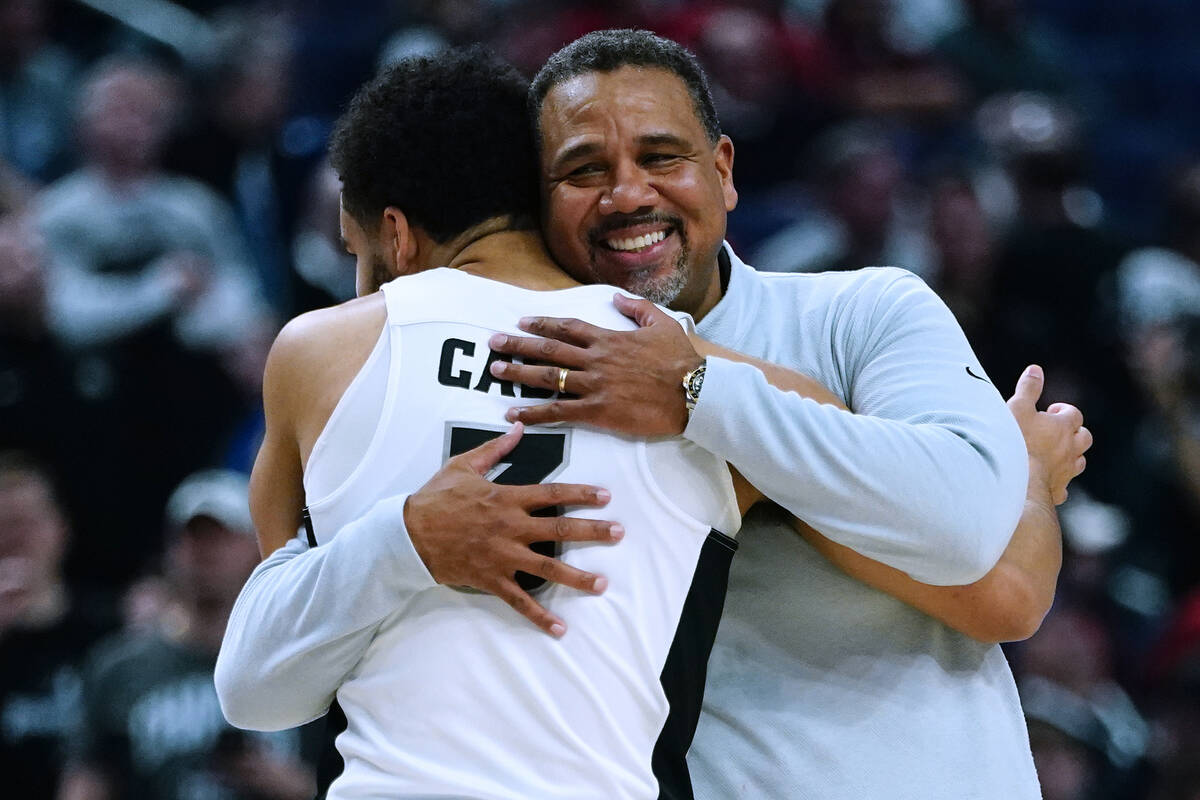 Providence coach Ed Cooley, right, hugs guard Matteus Case as he comes off the court during the ...