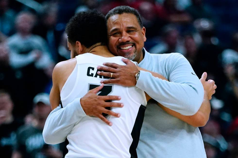 Providence coach Ed Cooley, right, hugs guard Matteus Case as he comes off the court during the ...