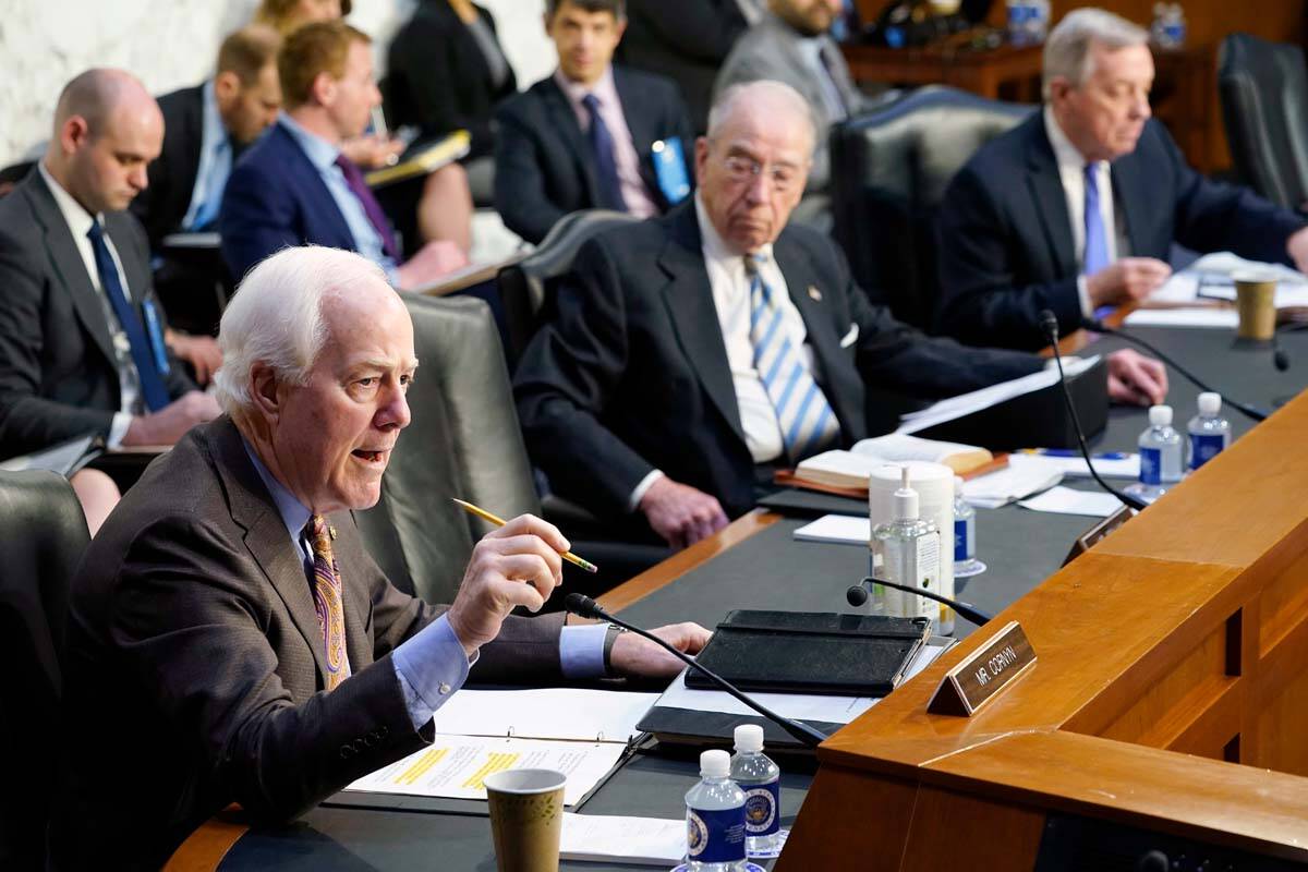 Sen. John Cornyn, R-Texas, left, speaks during the Senate Judiciary Committee confirmation hear ...