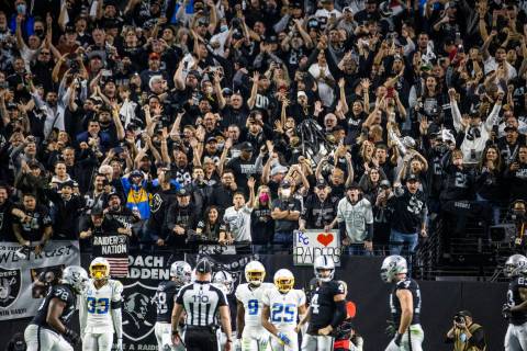 Raiders fans celebrate a late score over the Los Angeles Chargers during the second half of an ...