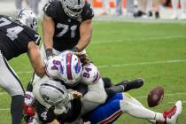 Las Vegas Raiders quarterback Derek Carr (4) looses control of the ball while being tackled by ...