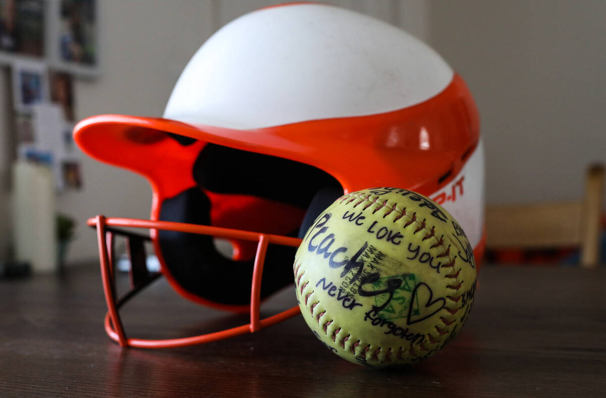 Georgia Durmeier’s softball helmet and softball signed by players from her team, with he ...