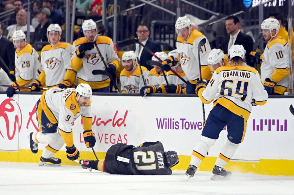 Vegas Golden Knights center Brett Howden (21) lies on the ice after a hit by Nashville Predator ...