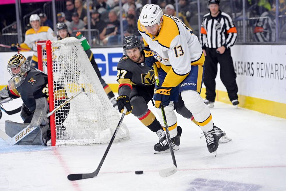 Vegas Golden Knights defenseman Shea Theodore (27) and Nashville Predators center Yakov Trenin ...